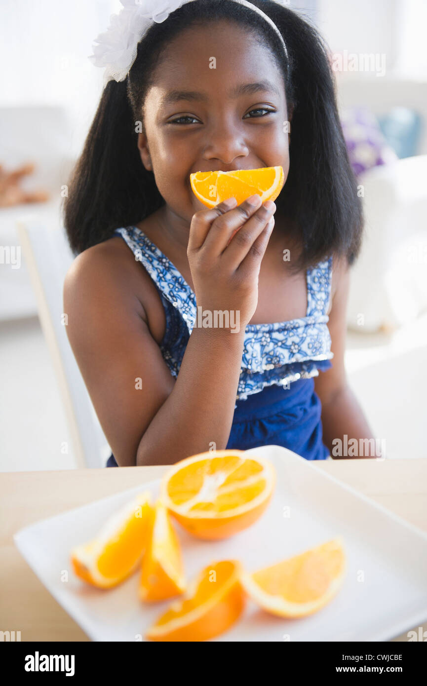 Black girl eating oranges Stock Photo Alamy