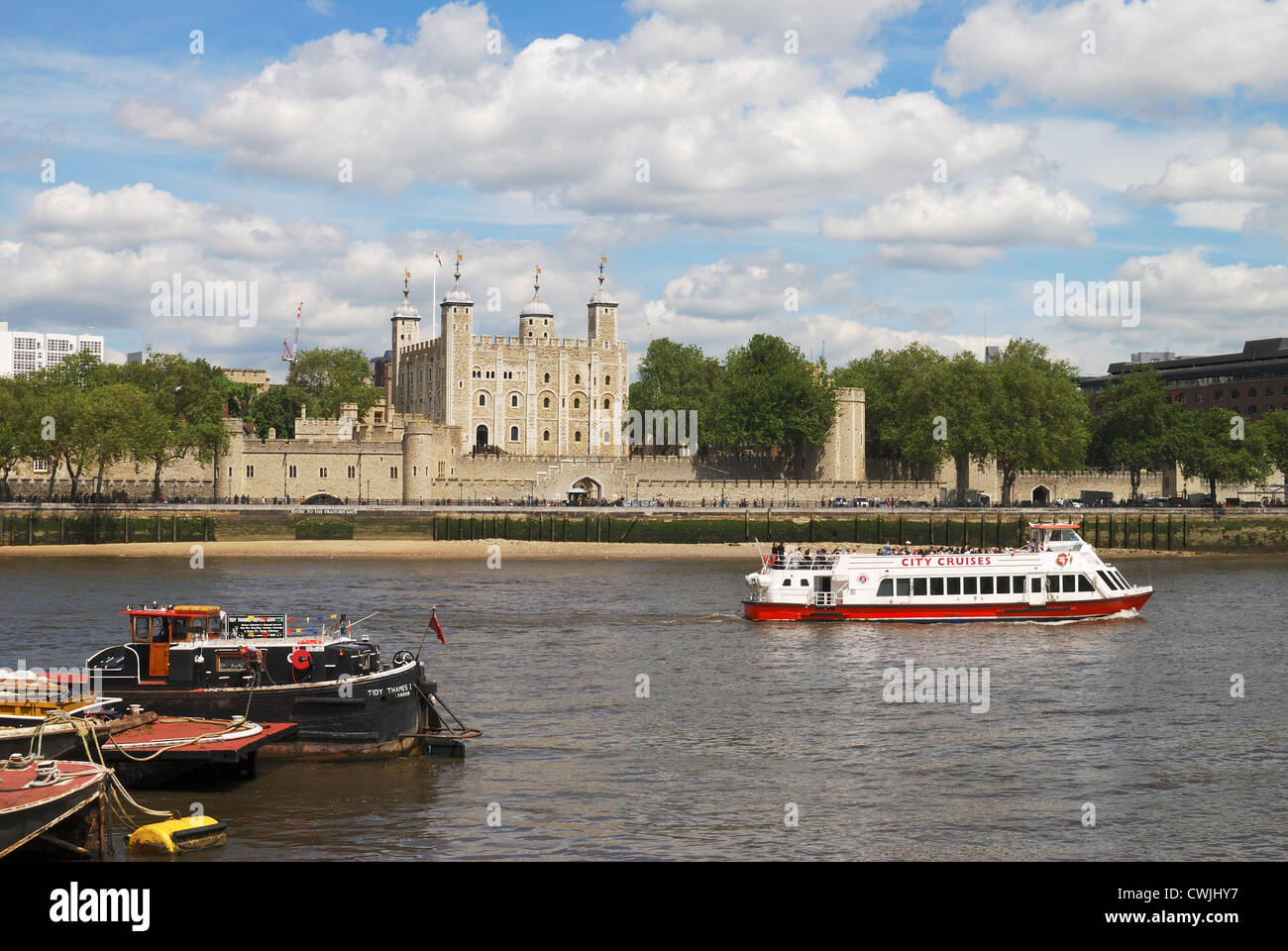 London. England. The Tower of London castle with tourist sightseeing boat on River Thames. View from South Bank Stock Photo