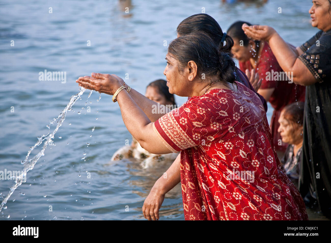 Woman praying in the Ganges river. Varanasi (Benares). India Stock Photo
