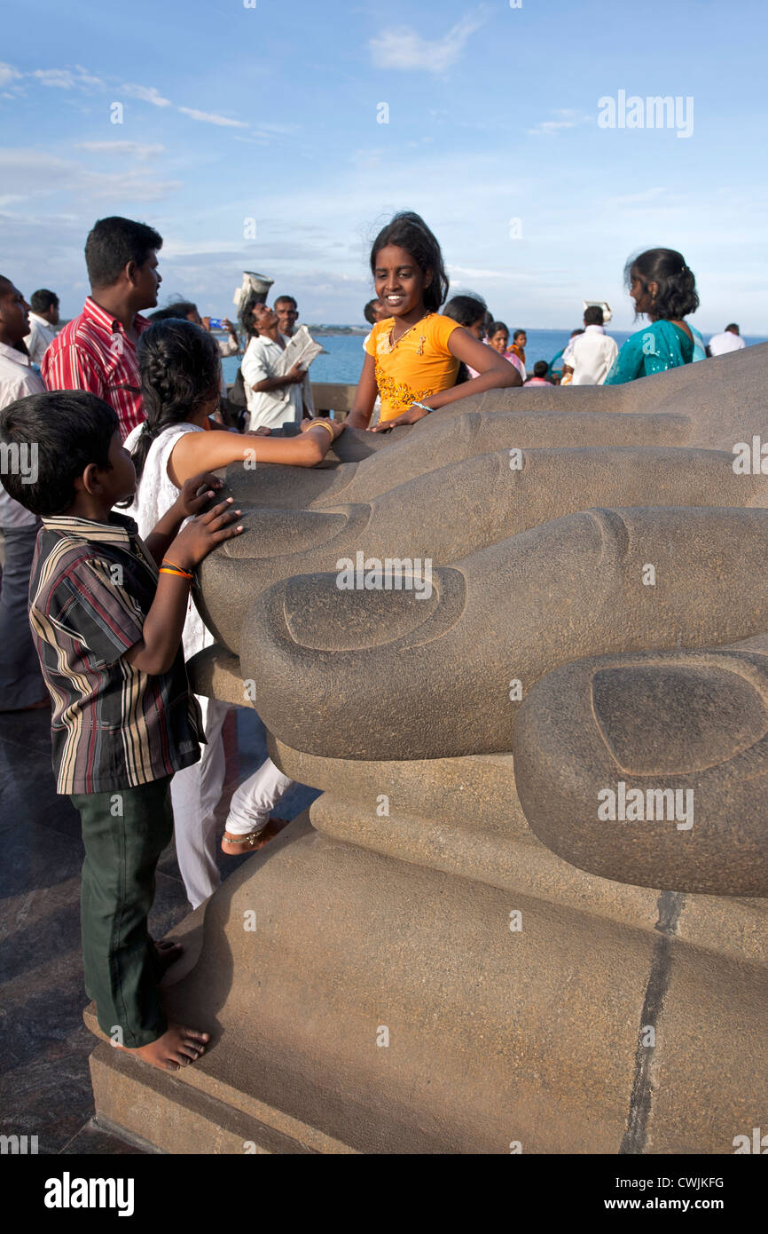 Kids touching the toes of Thiruvalluvar colossal sculpture (indian poet). Kanyakumari. India Stock Photo