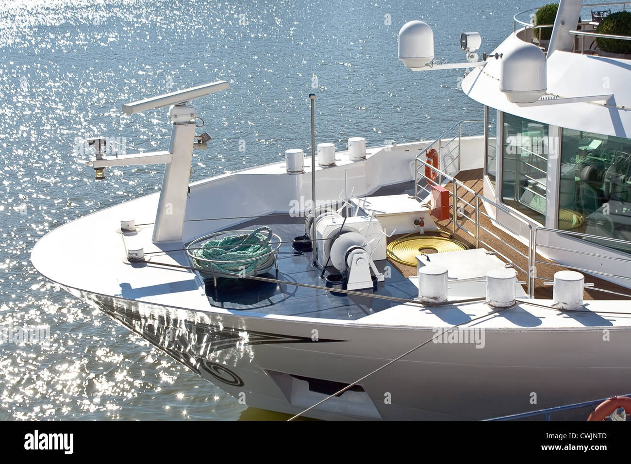 Bow and deck of the ship beside glistening water Stock Photo