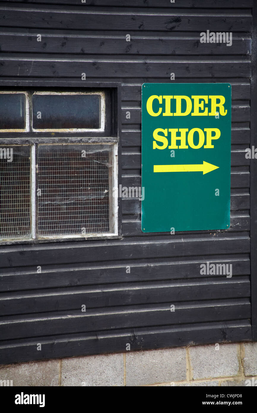 Cider shop sign with arrow on side of black building at Burley, New Forest, Hampshire UK in