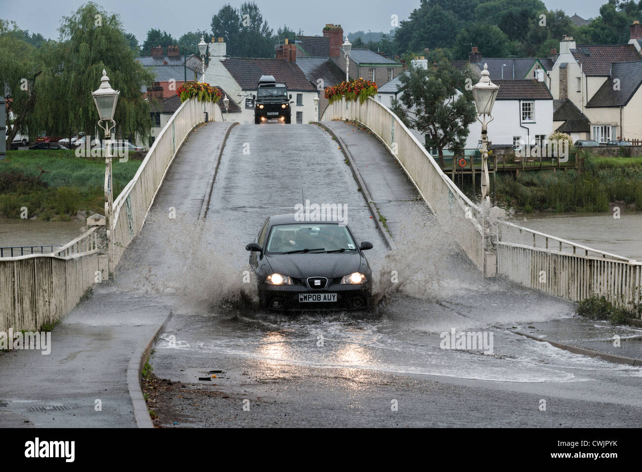 SEAT CAR IN FLOOD ON OLD WYE BRIDGE CHEPSTOW, WITH 4x4 ON BROW OF HILL SUMMER 2012 Stock Photo