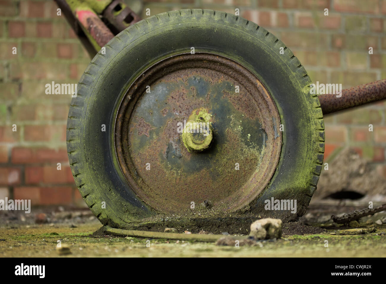Old flat rusty abandoned tyre Stock Photo