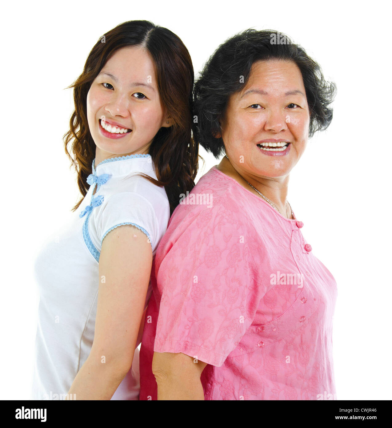 Portrait of two Asian women back to back, over white background Stock Photo