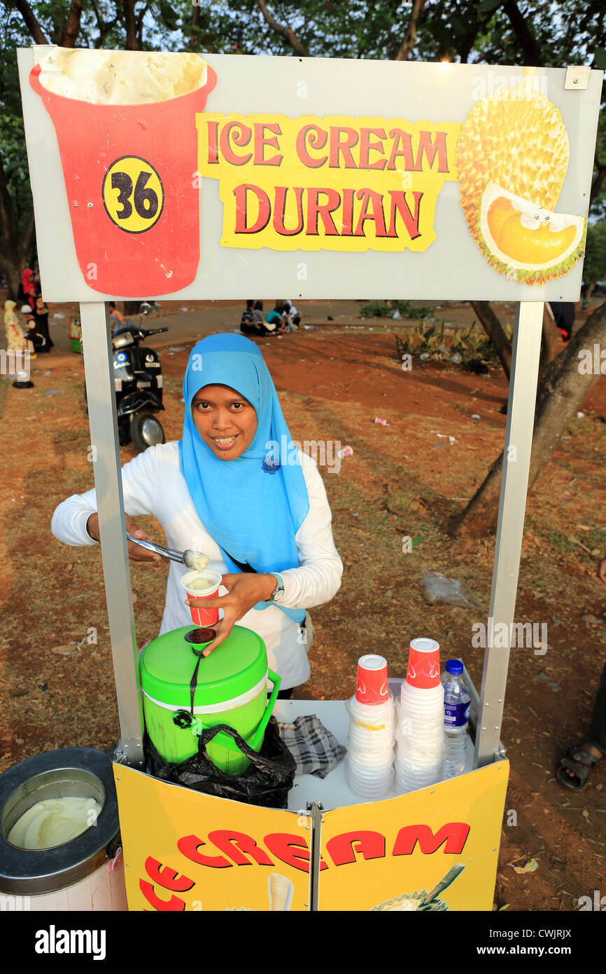A Muslim woman sells Durian flavored ice cream during Ramadan celebrations in Merdeka Square Stock Photo