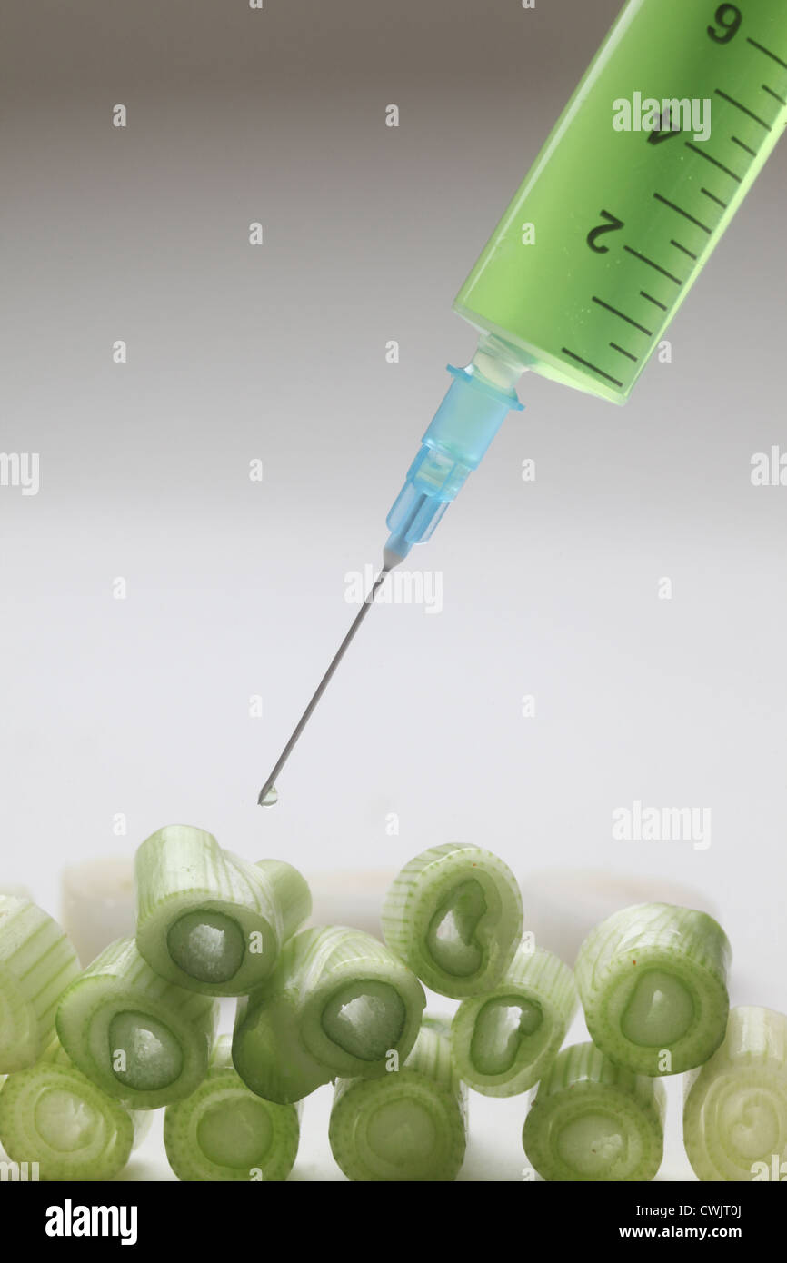 Injection into fresh young onion Stock Photo
