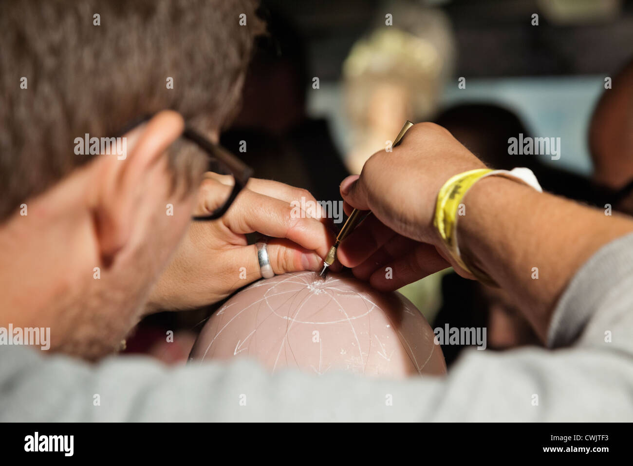 England, London, Madame Tussauds, Demonstration of Implanting Hair into Waxwork Head Stock Photo