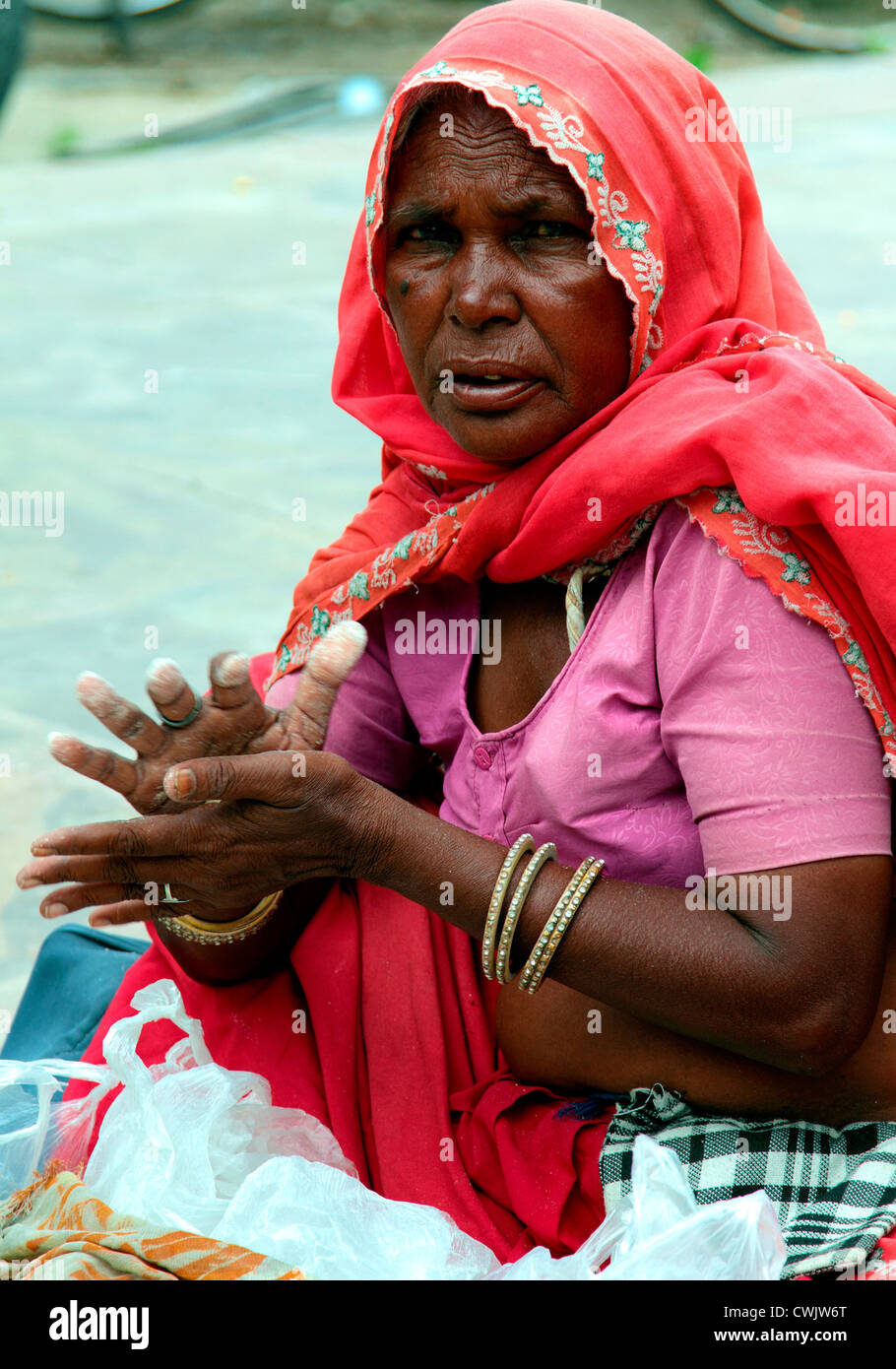 Old woman,market,India,Indian culture,market vendor,bazaar, street vendor,Road side,Descriptive color.Traditionally Indian. Stock Photo