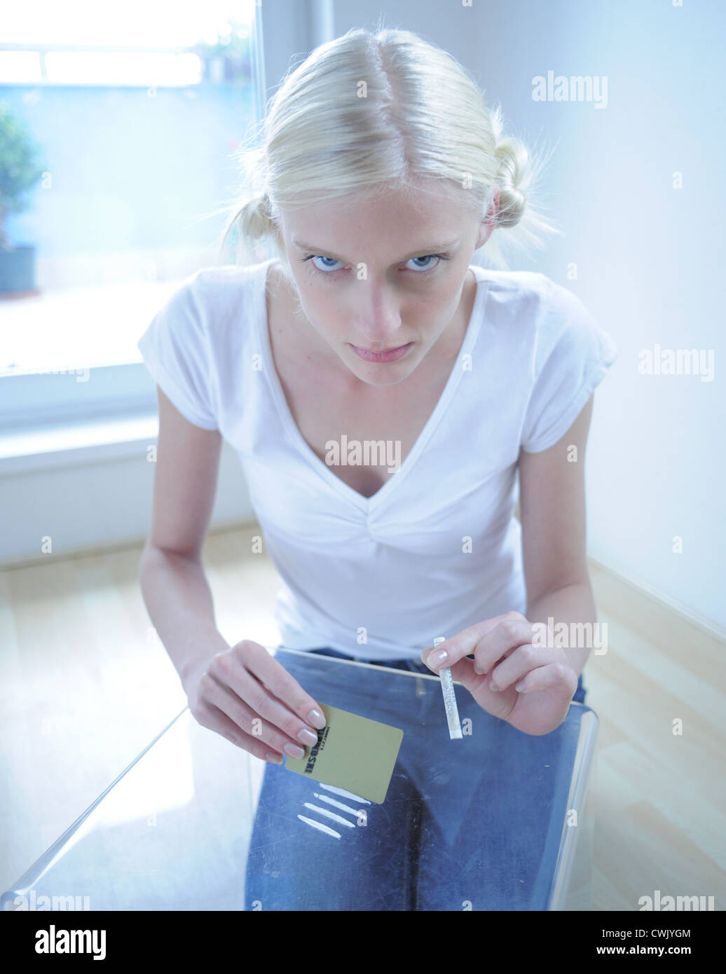 Young woman sniffing drug Stock Photo