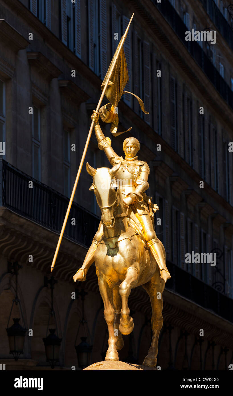 Joan of Arc statue, Gold equestrian statue of Joan of Arc holding a flag mounted on horseback Place des Pyramides Rue de Rivoli Paris France EU Europe Stock Photo