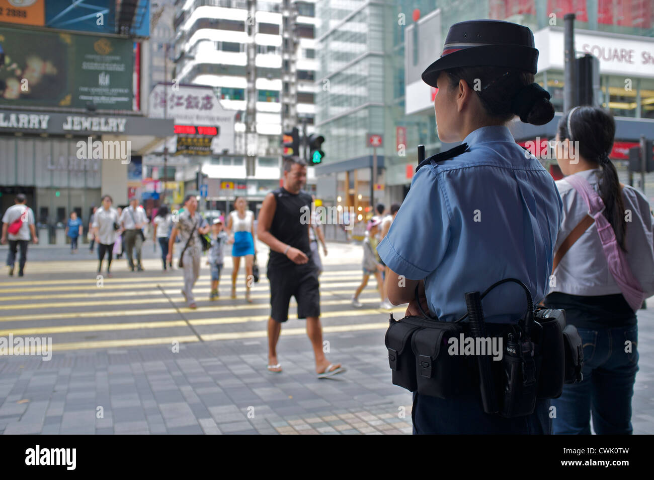 Hong Kong police woman patrolling on street. 25-Aug-2012 Stock Photo