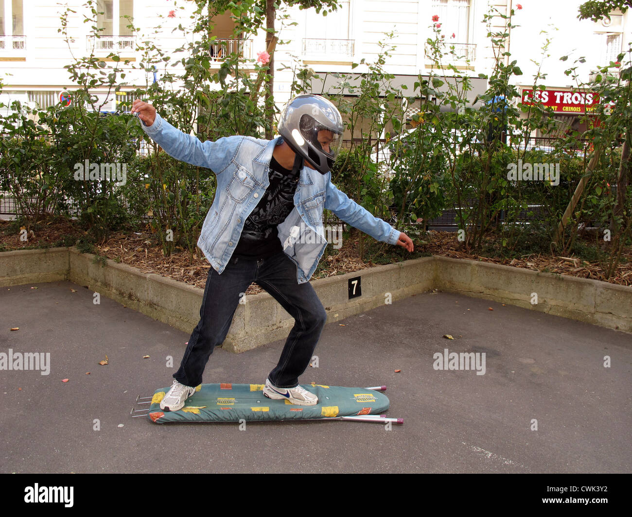 boy surfing on ironing board, Paris, France Stock Photo Alamy