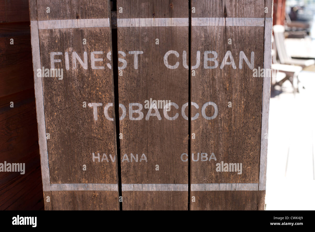 Chest of Finest Cuban Tobacco out front a red wooden house Stock Photo