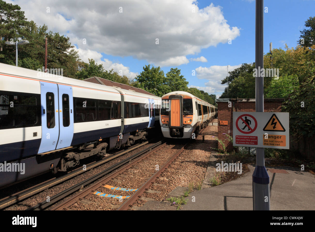 Two electric express trains passing on electrified railway with danger