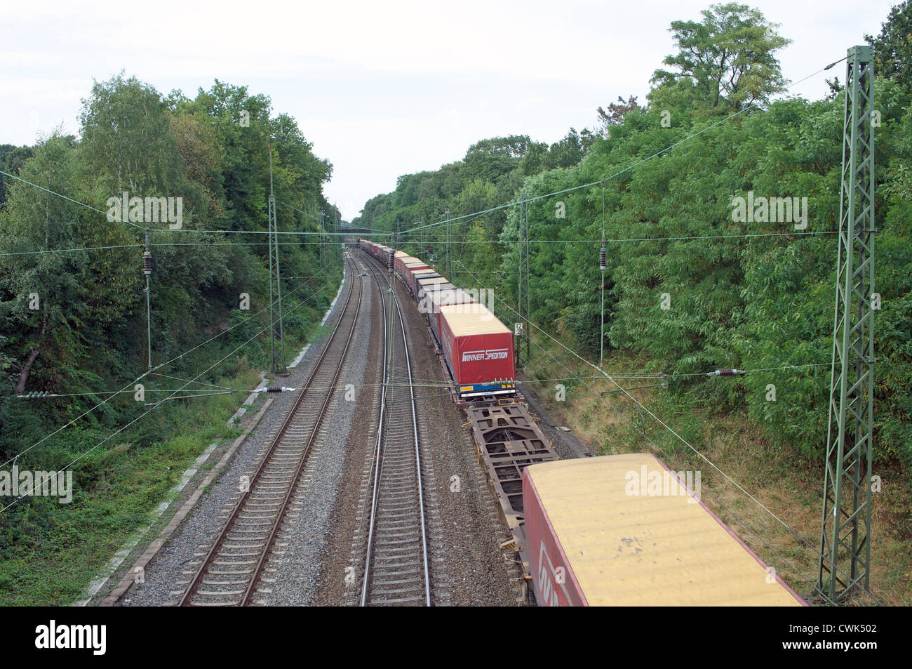 German Railways freight train loaded with Winner Spedition trucks passes through Leichlingen, North Rhine-Westphalia, Germany. Stock Photo