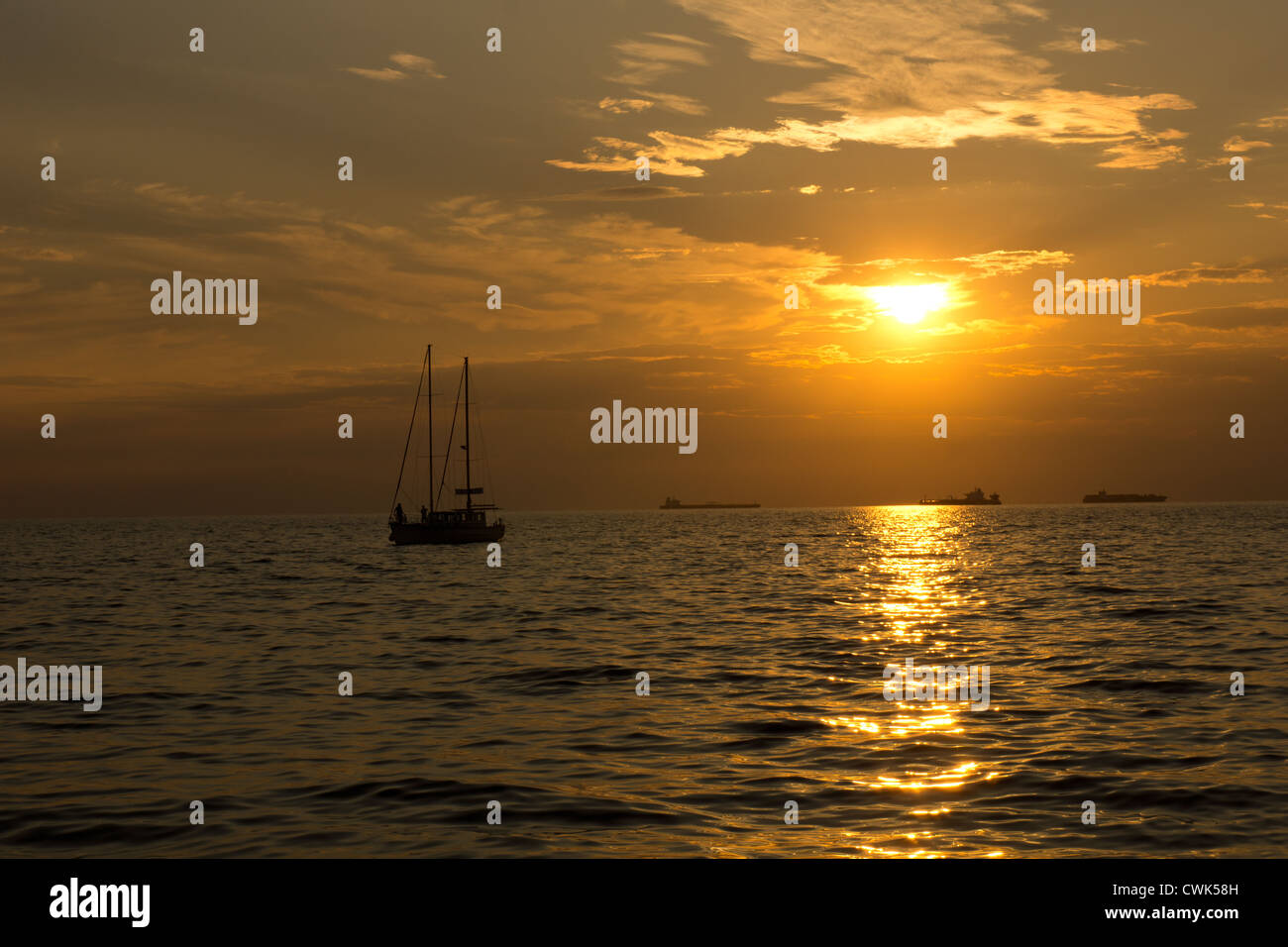 Sea ships and sailboats silhouettes against sunset Stock Photo - Alamy