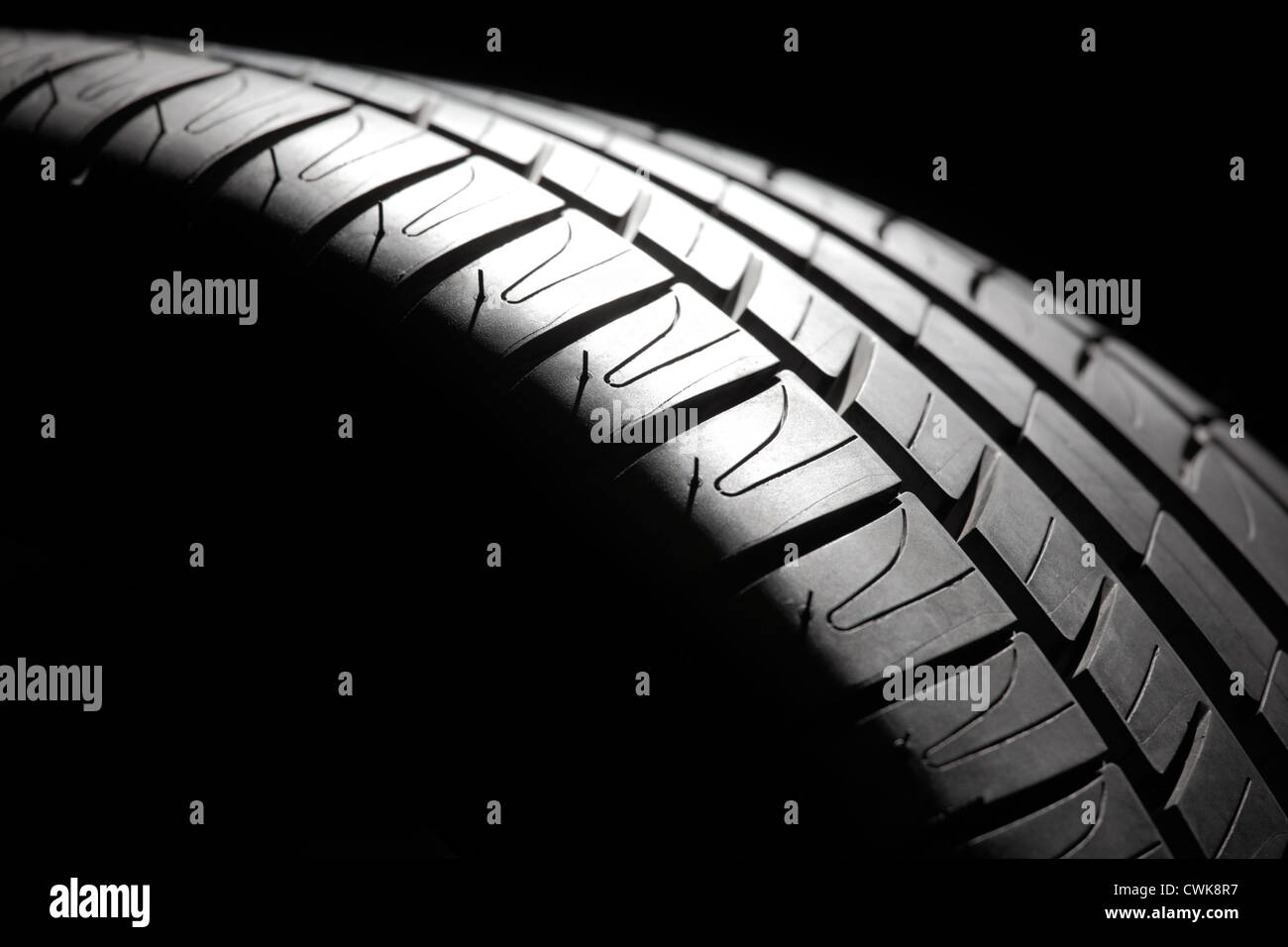 Modern highperformance sport summer tire closeup in a low key. Studio