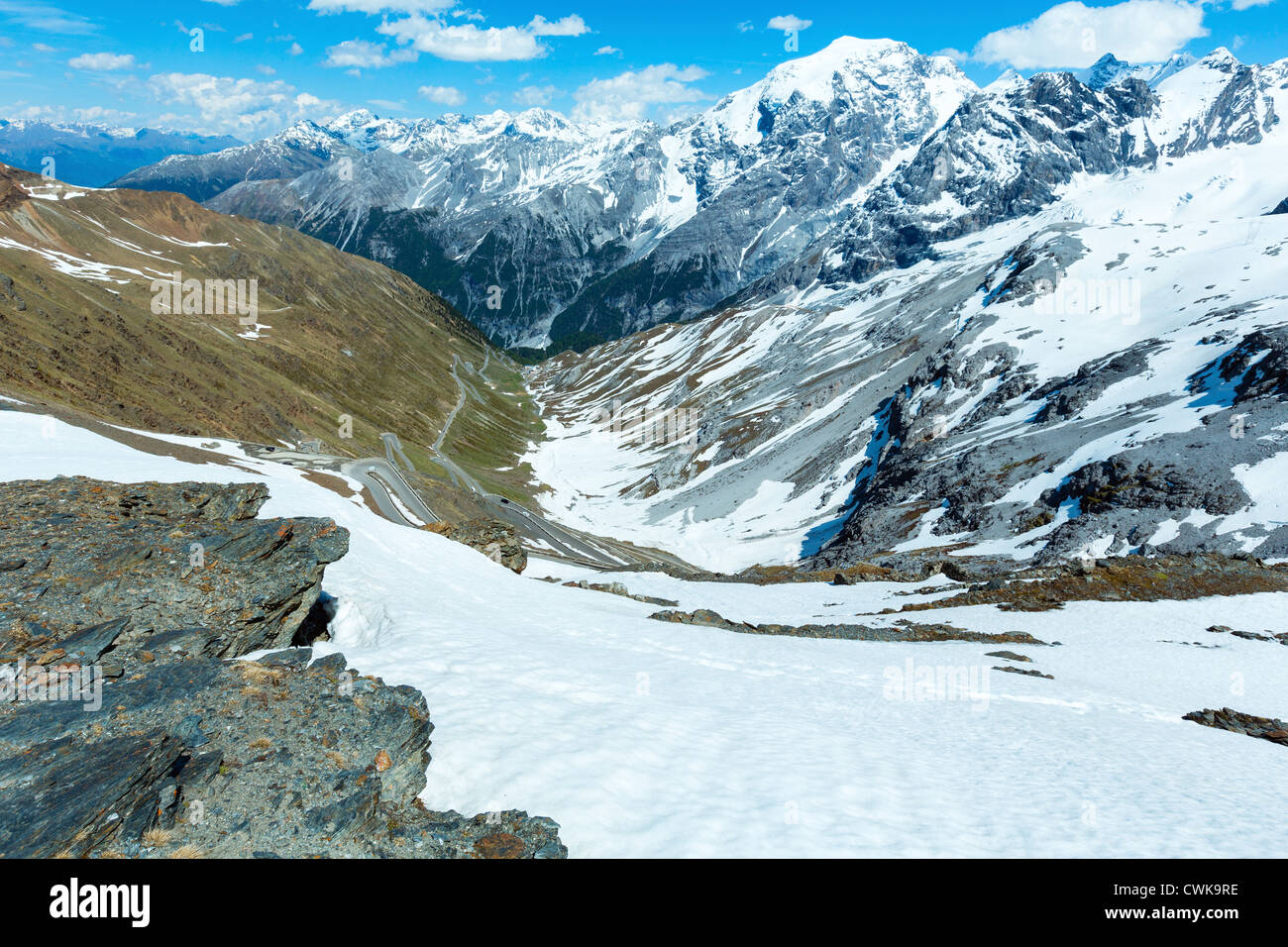 Summer Stelvio pass with alpine road and snow on slope (Italy) Stock Photo