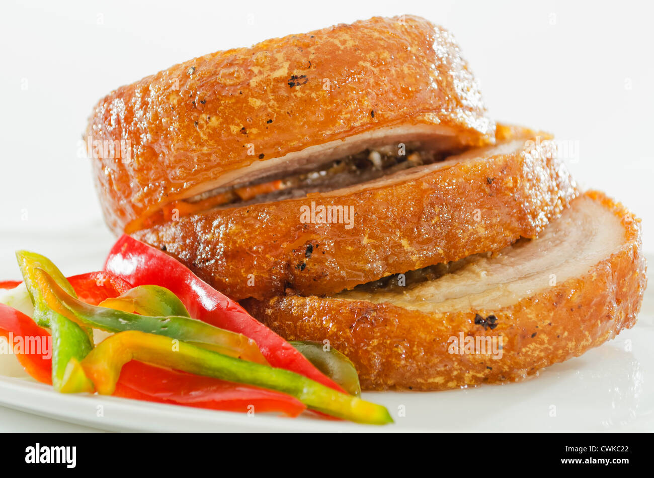 Three pieces of deepfried pork chop with chopped red and green pepper
