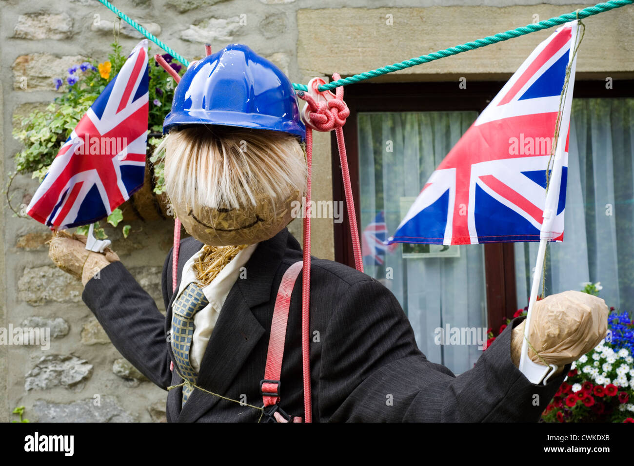 scarecrow at kettlewell festival depicting boris johnson on a zip wire Stock Photo