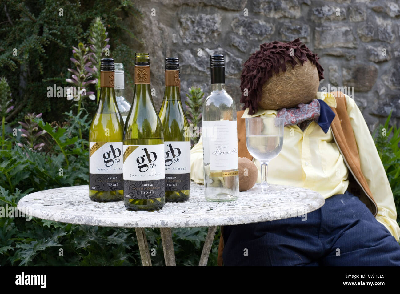 scarecrow at kettlewell festival depicting a man drinking wine at a