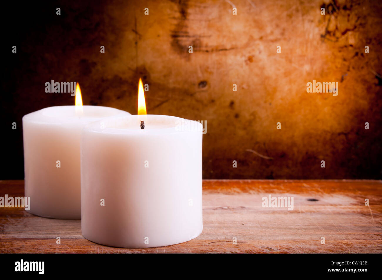 White candles burning with a textured vintage background Stock Photo Alamy