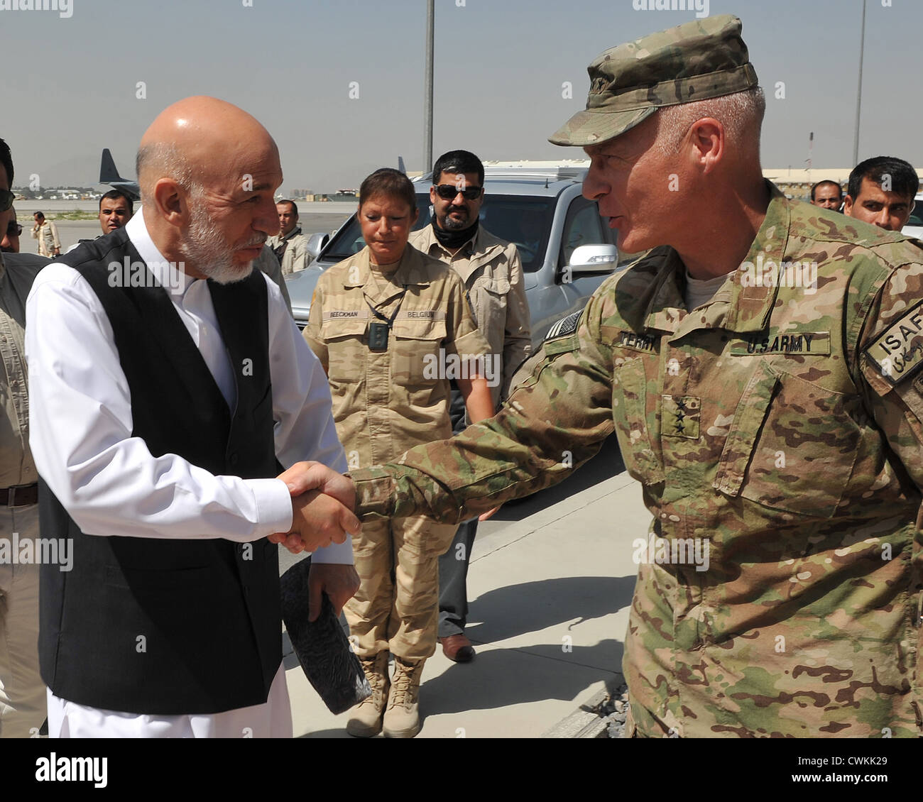 US Army Lt. General James Terry greets Afghan President Hamid Karzai on the flight line at Kabul International Airport August 21, 2012. Stock Photo