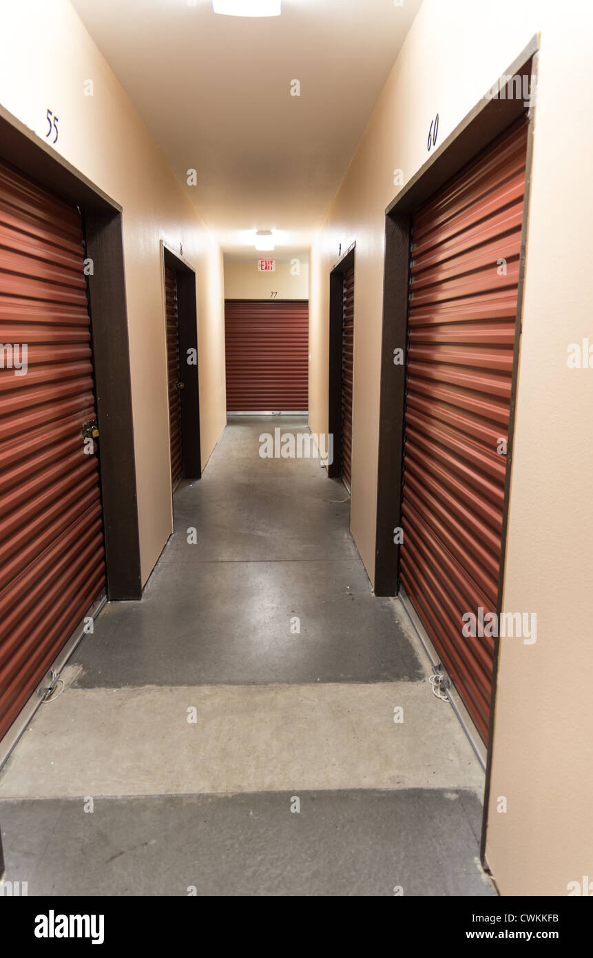 Hallway of a self storage facility showing doors Stock Photo