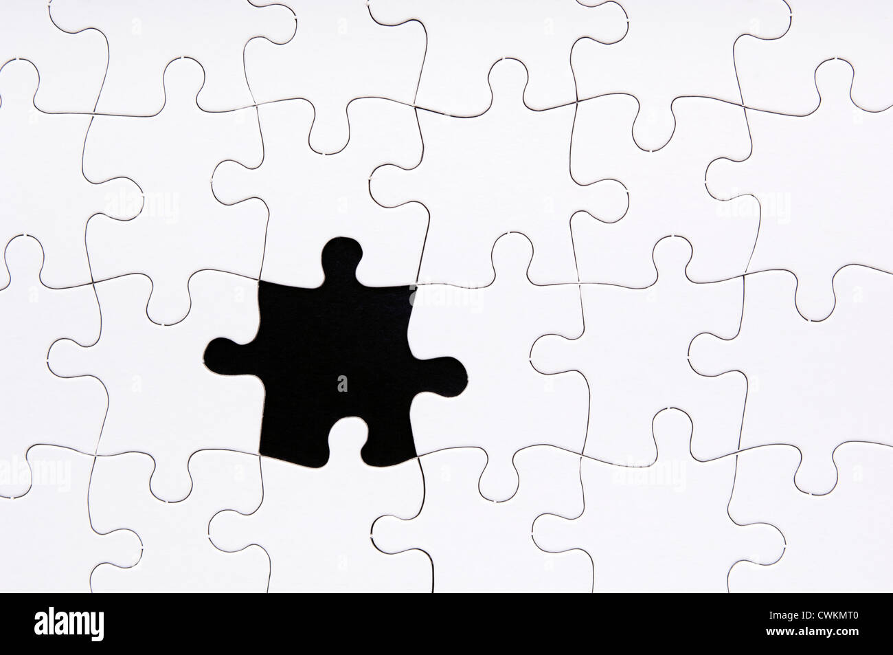 Jigsaw puzzle in white with a missing piece Stock Photo