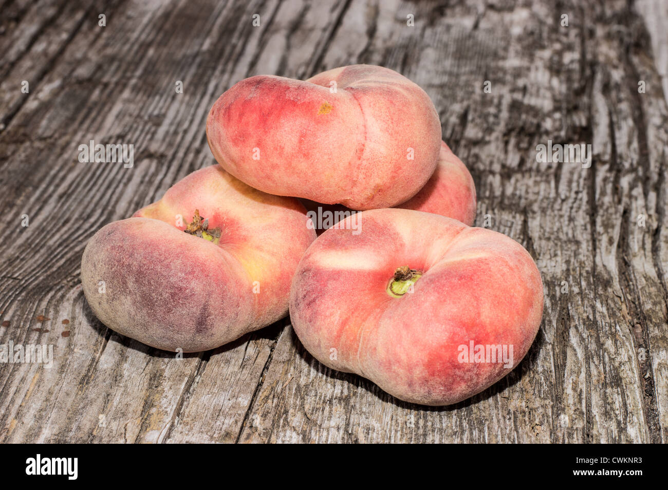 Heap of Wild Peaches on wooden background Stock Photo
