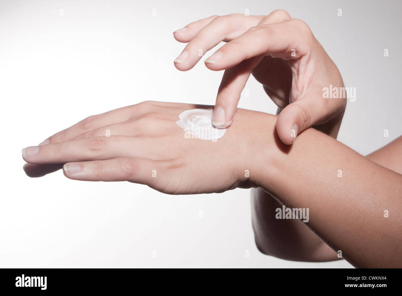 woman hands using skin cream Stock Photo