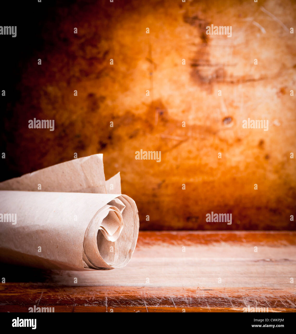 Old paper parchment scroll rolled up with a vintage background with copy space Stock Photo