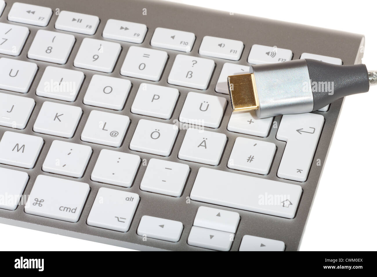 HDMI Cable on computer keyboard isolated on white background Stock