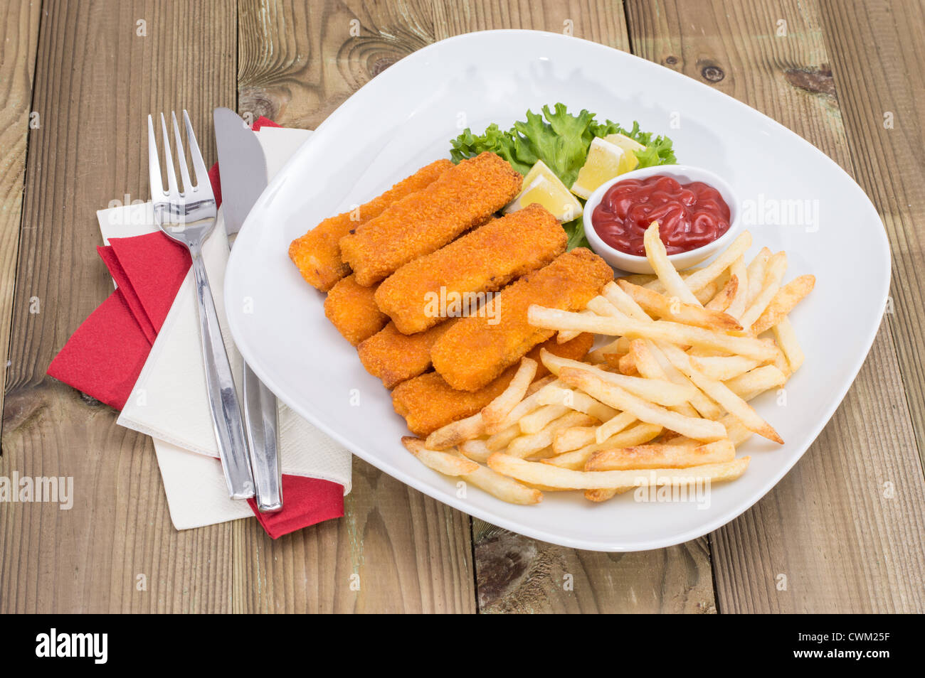 Portion of Fish Fingers and Chips on wooden background Stock Photo - Alamy