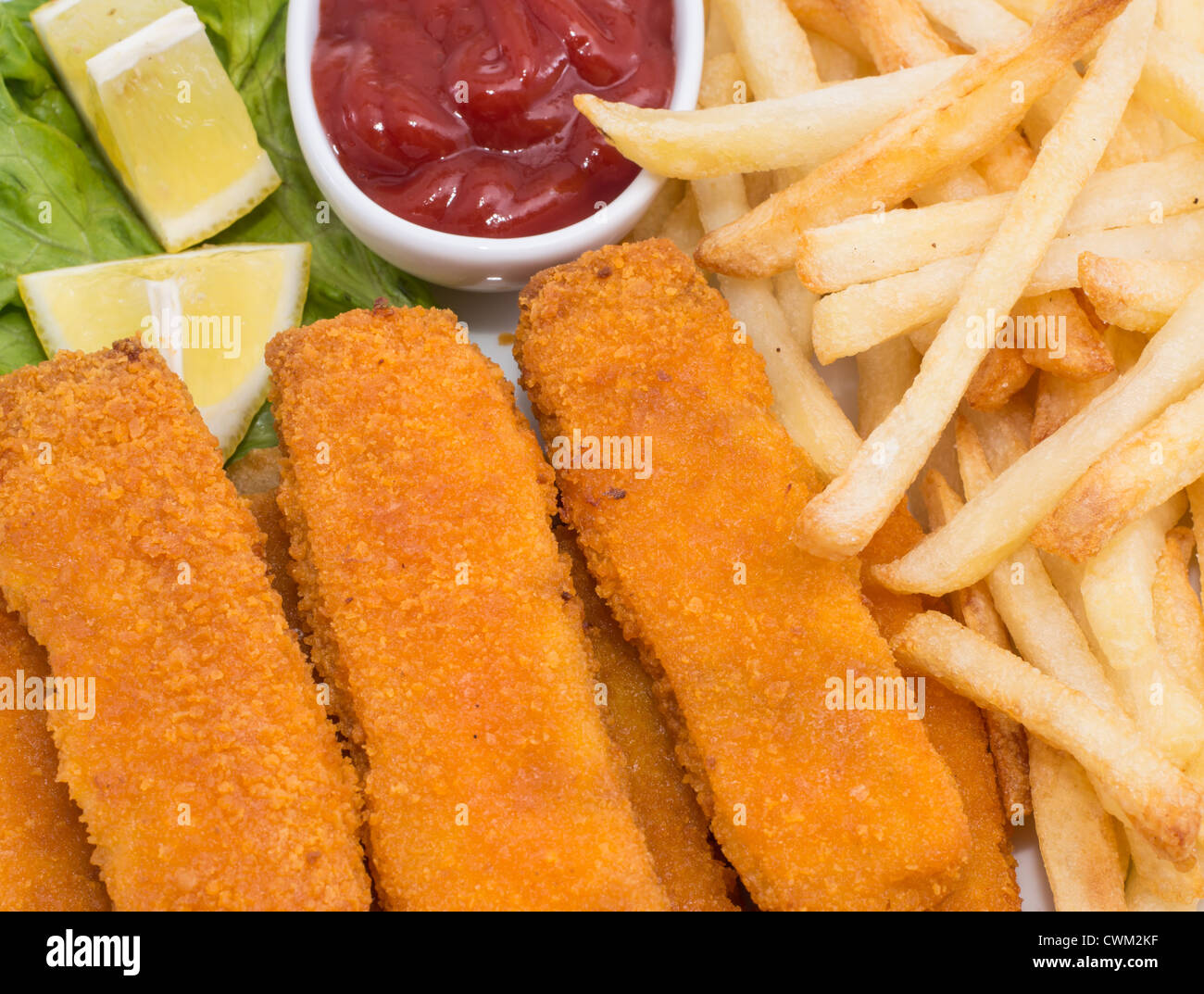 Fish Fingers with Chips and a bowl of Ketchup (macro view Stock Photo