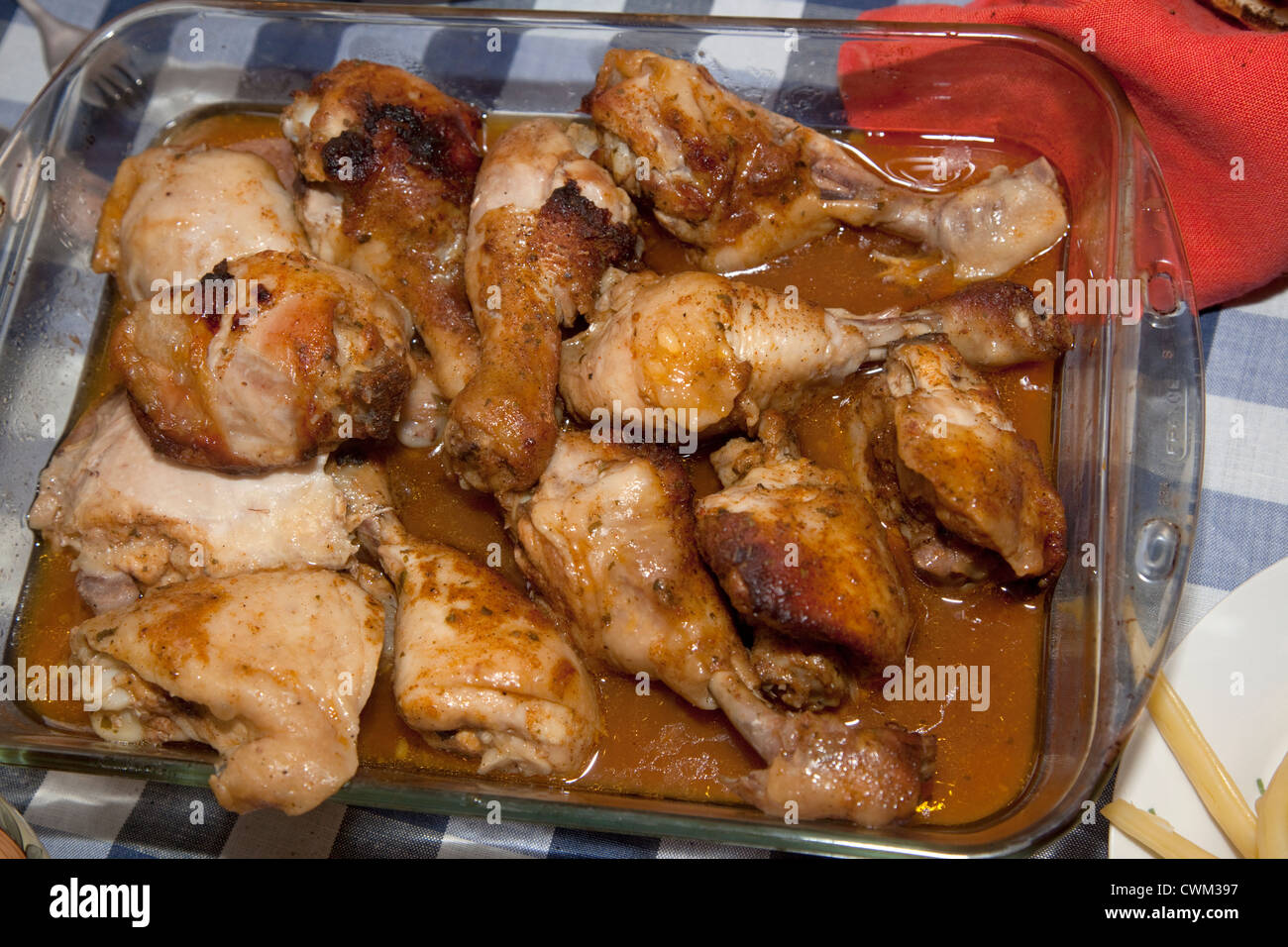 Glass baking dish filled with baked chicken covered with gravy a