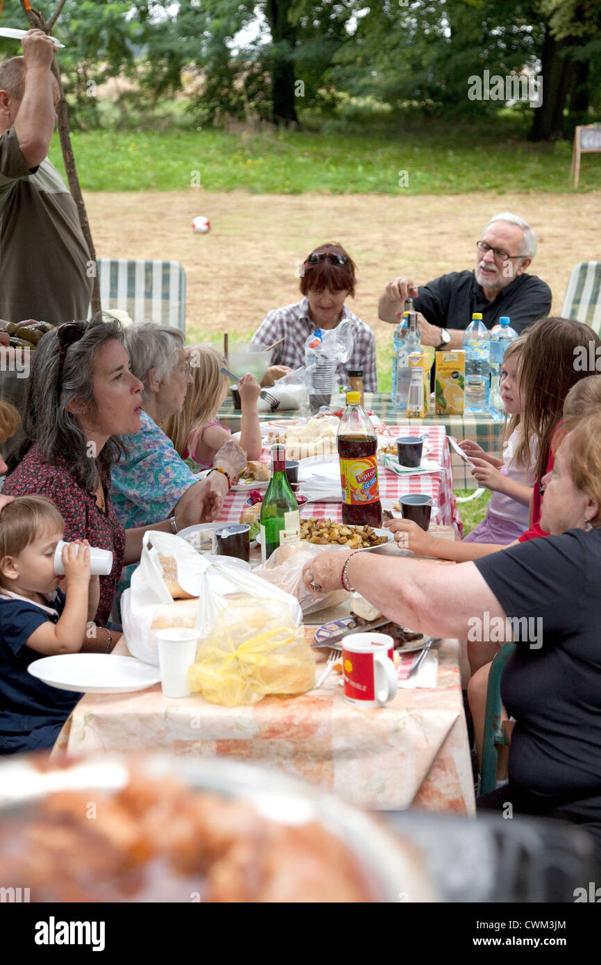 Extended four generation Polish family having an outdoor dinner in their yard. Zawady Central Poland Stock Photo