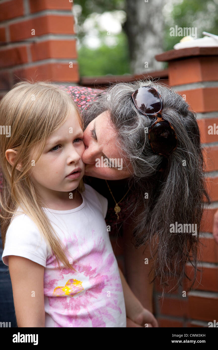 French mom trying to cheer up her daughter with a loving kiss age 8 and 35. Zawady Central Poland Stock Photo