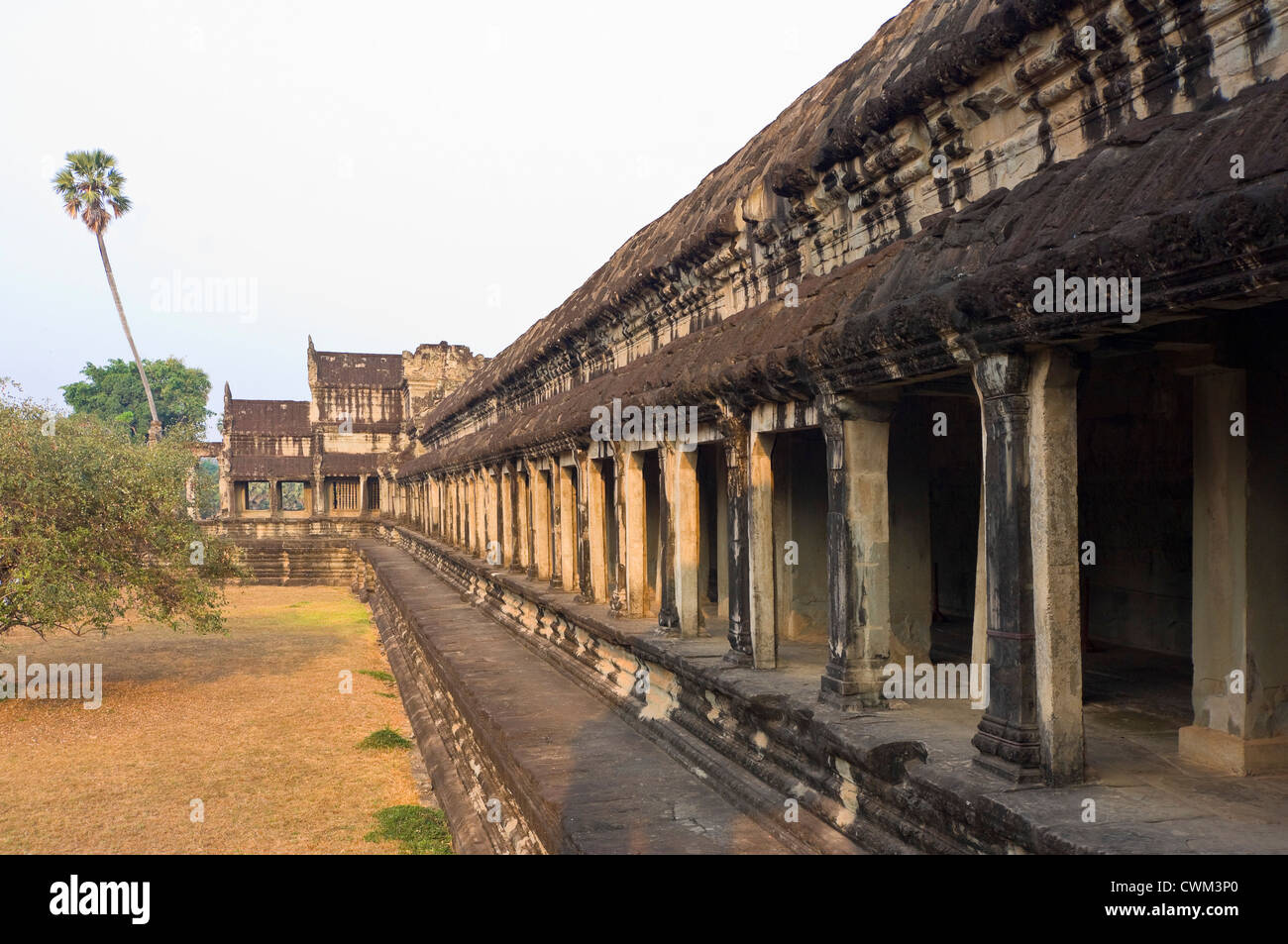 Horizontal view down the south side of the amazing architecture at Angkor Wat in the morning sun. Stock Photo