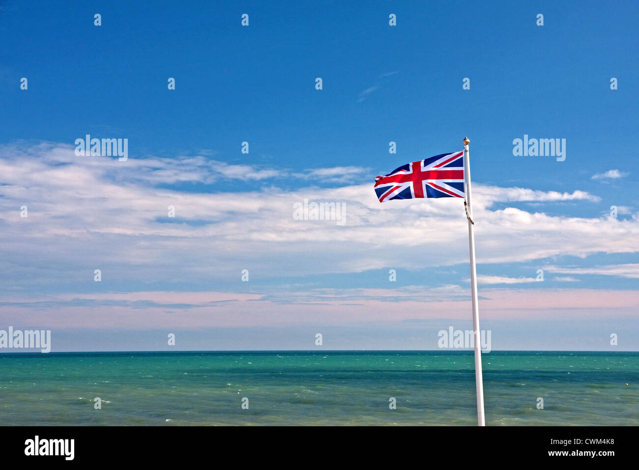 Union flag flying against summer blue sky and sea Stock Photo - Alamy
