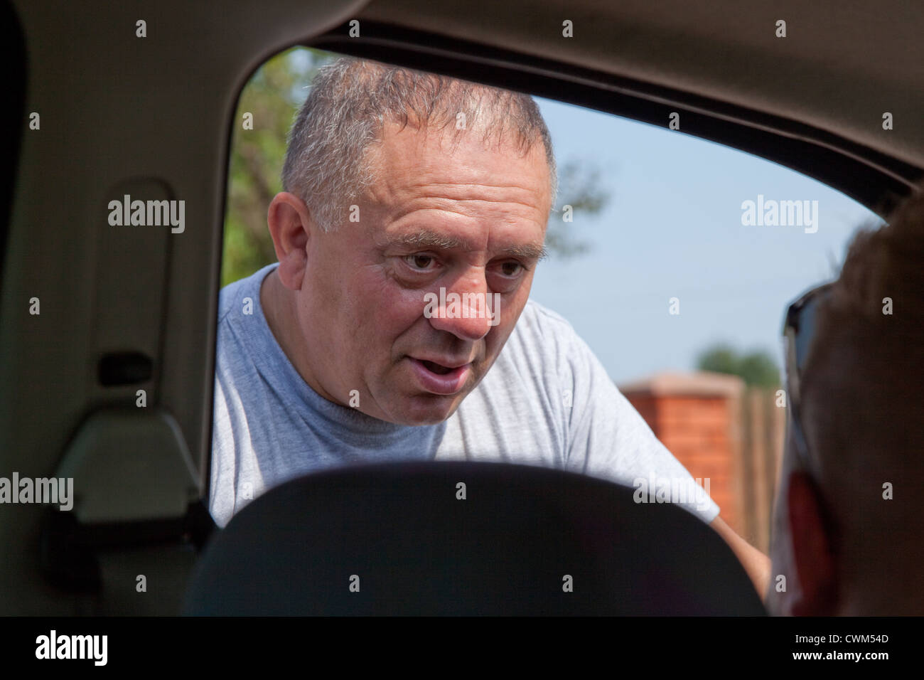 Polish neighbor communicating the day's events to our driver. Zawady Central Poland Stock Photo