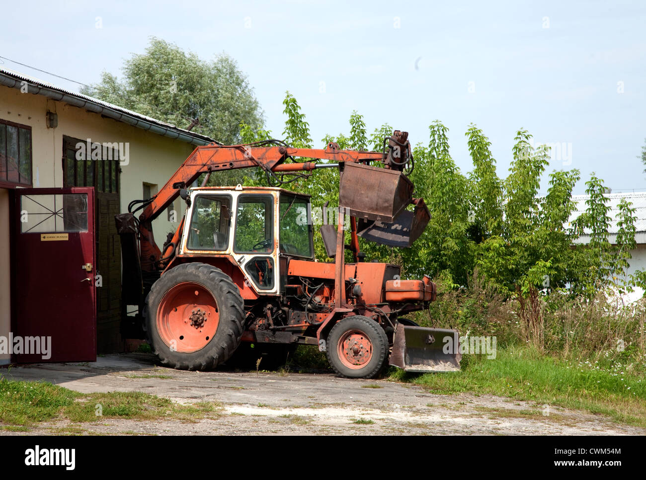 Polish tractor with plow fitted with a rear overhead scoop. Rzeczyca