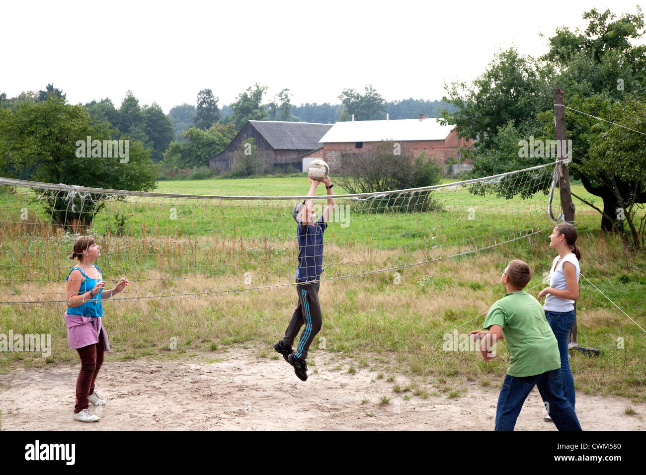 Polish village children and teens playing sandlot volleyball. Mala Wola Central Poland Stock Photo