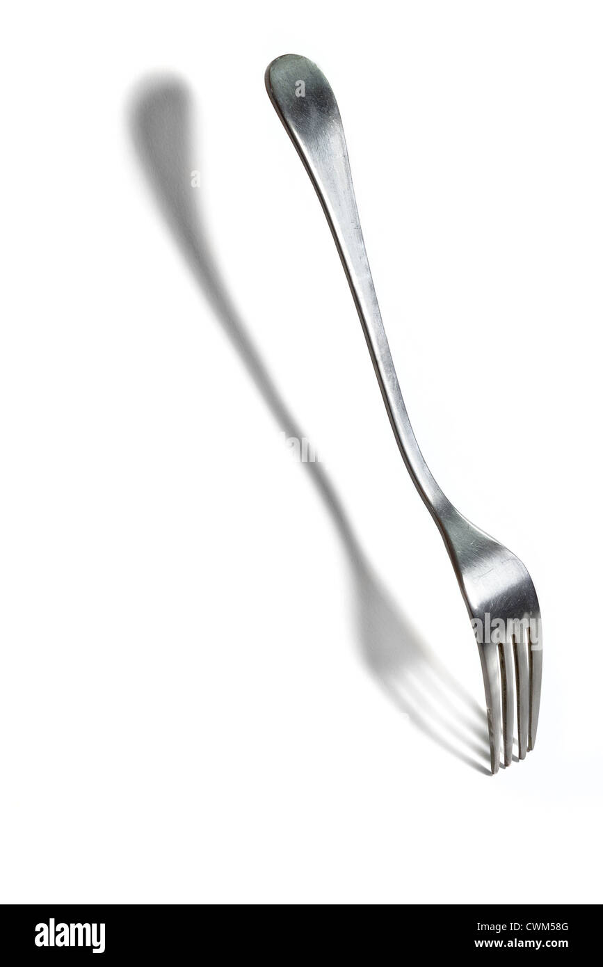 suspended steel fork and his shade on white background Stock Photo