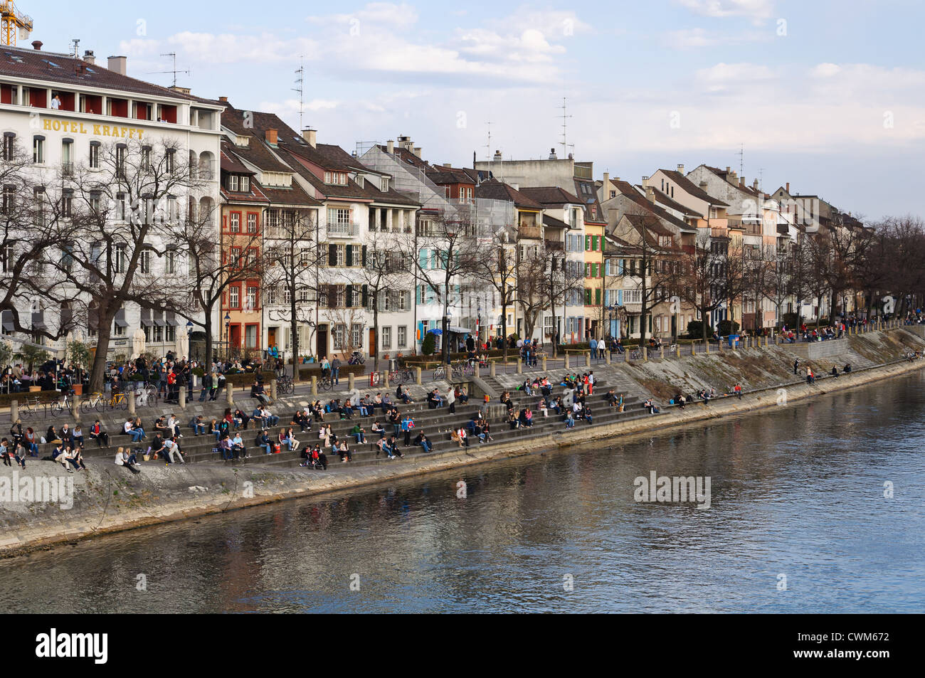 People relaxing on the Rhine bank in Basel, Switzerland. Stock Photo