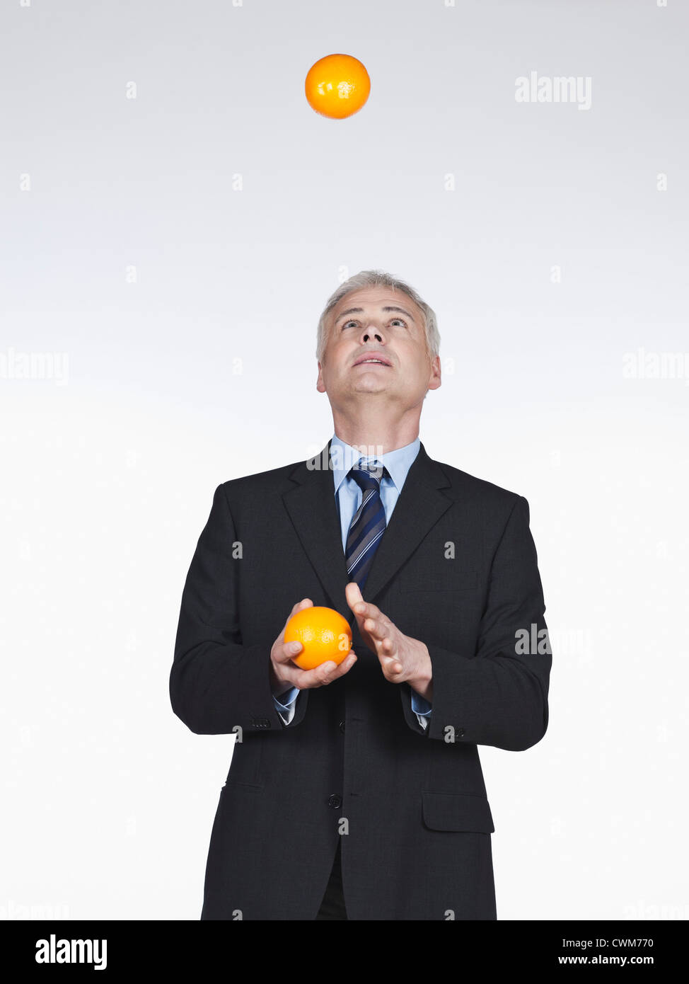 Mature man juggling with oranges Stock Photo Alamy