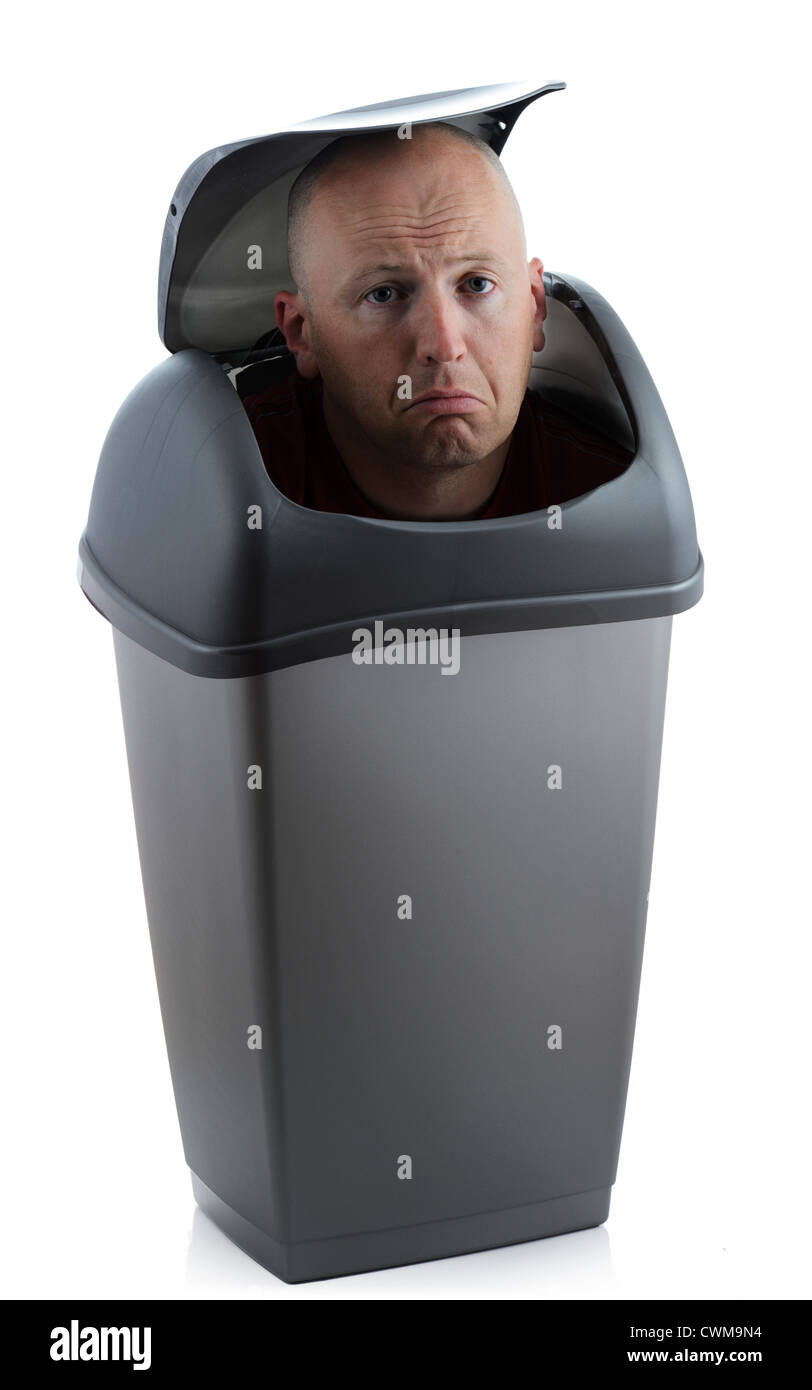 Man in a bin redundant not needed and sad Stock Photo