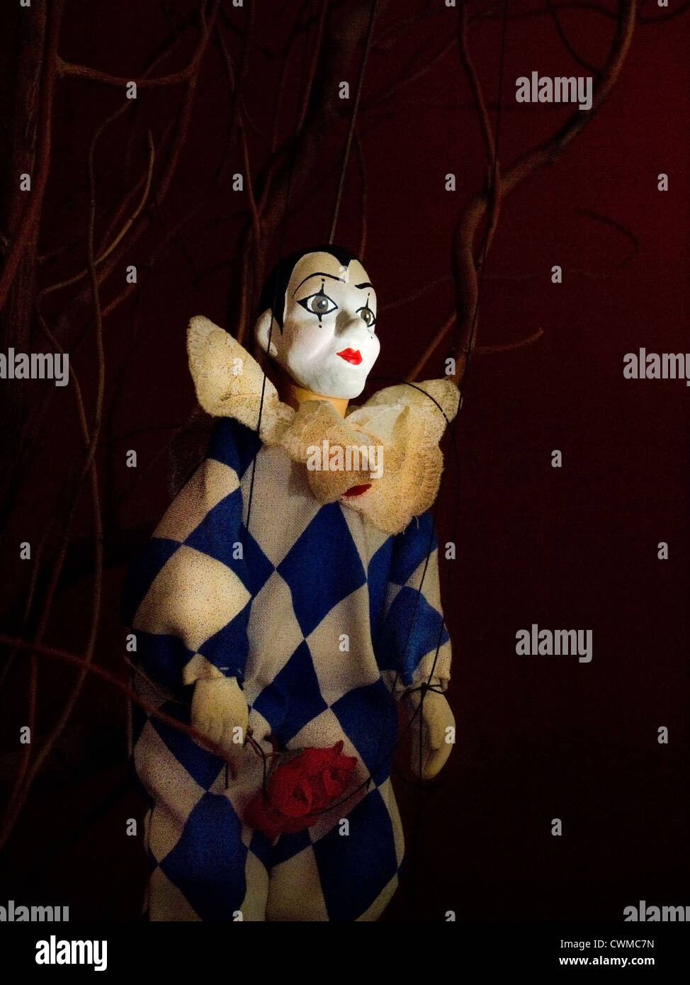 A puppet Pierrot caught in the spotlight Stock Photo