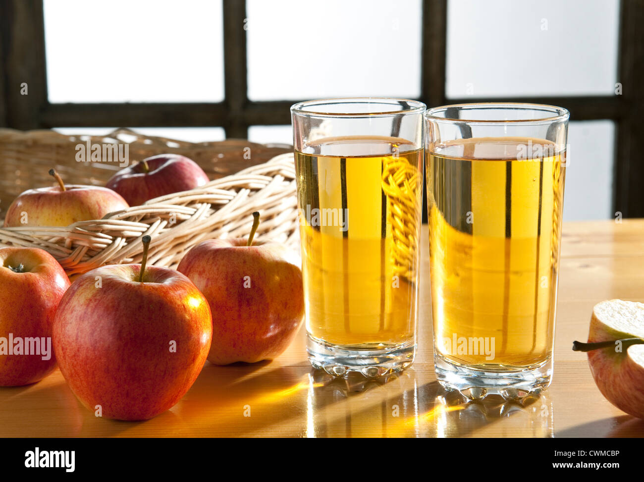 Apple juice -Two glasses of apple juice on a kitchen table, with apples ...